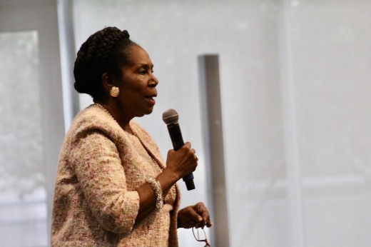 a woman holds a microphone