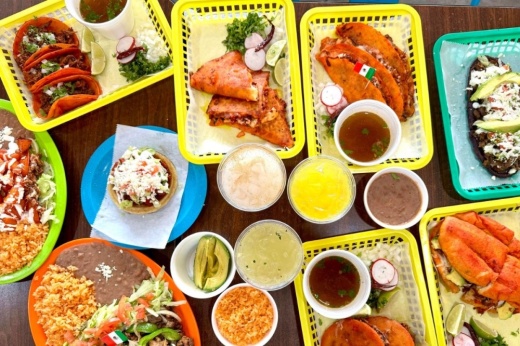 a spread of Mexican food on colorful trays