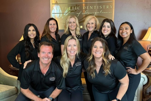 An image of the three dentists at the office and staff.