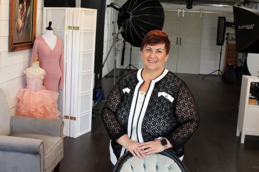 Female posing for a picture in a photography studio.