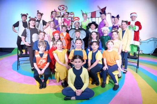 Group of children wearing costumes posed for a picture.