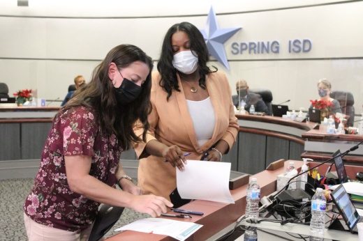 Carmen Correa and Natasha McDaniel sign documents