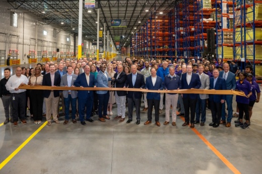 About 150 Southwire employees and officials are lined up behind a ribbon during a ribbon cutting ceremony Aug. 25.