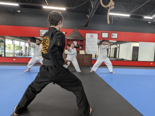 A martial arts instructor teaches a class at Bushi Ban DFW