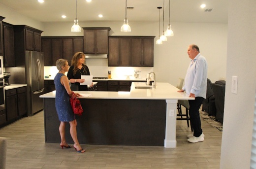 realtor showing a couple a home