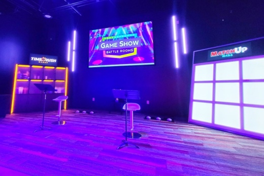 Inside a game show room with purple lighting