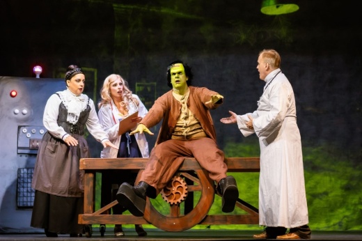 A scene is shown from a dress rehearsal with Frankenstein's monster in the center.