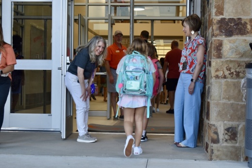 a young students walk into school