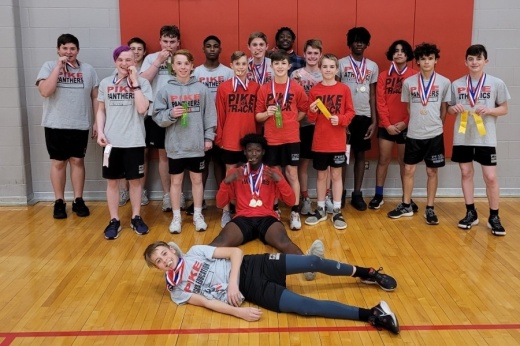 Students posing inside a gym