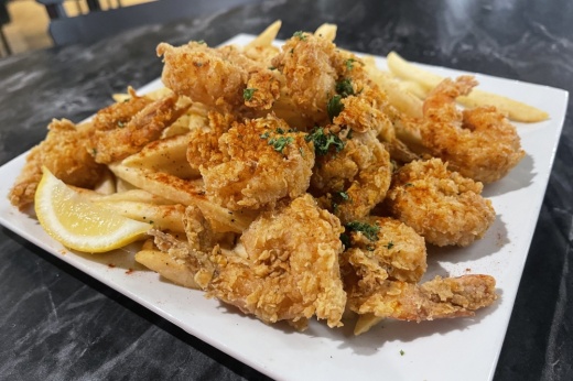 The shrimp platter comes with 10 fried shrimp and Cajun seasoned fries. (Grant Crawford/Community Impact)