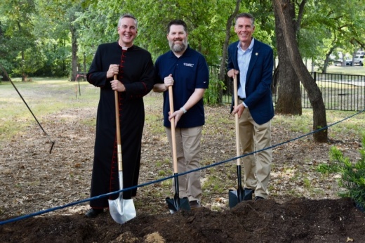 Men standing at ground breaking