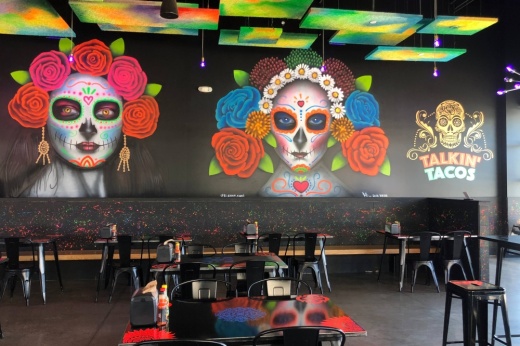 Interior of a restaurant with a Dia de Muertos mural.