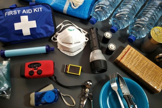 A table holds various emergency supplies