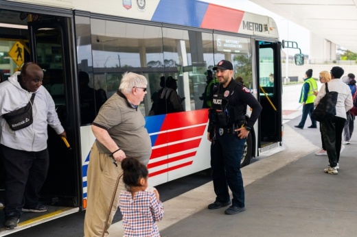 A photo of bus riders and METRO police.
