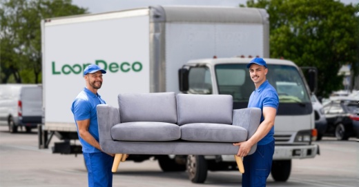 Two people moving a used couch