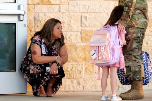 Principal greeting new student on first day of school