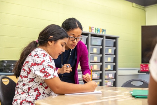 teacher working with student