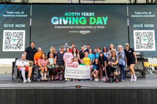 People on stage receiving a donation
