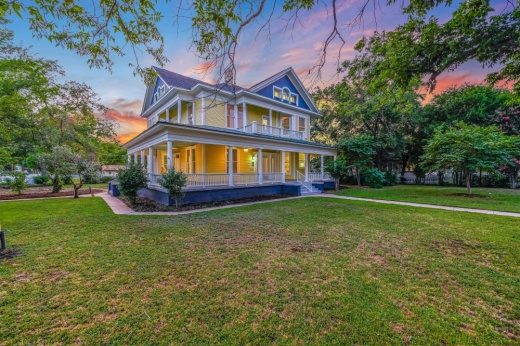 The two-story home's exterior is shown at dusk.