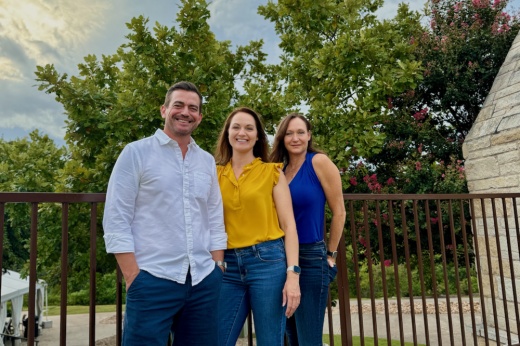 A man and two women smile