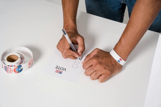 man filling out ballot