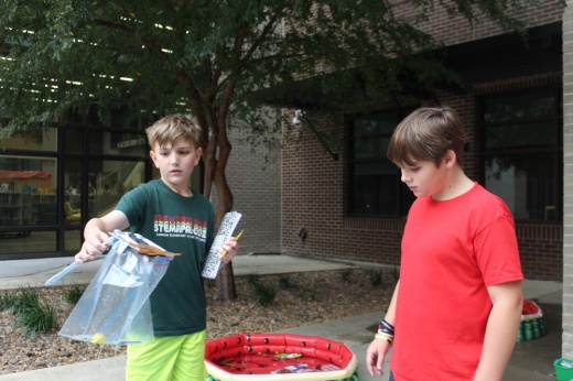 Two fifth grade students demonstrate how a trash-collecting device works on Nov. 1 at Cannon Elementary School.