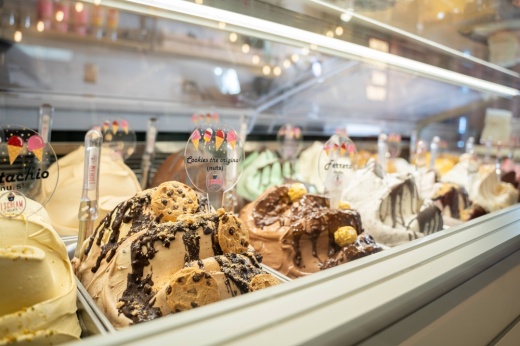 Various frozen gelato flavors in a cooler.