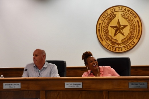 Mayor Pro Tem Na'Cole Thompson smiles from the dais.