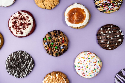 Variety of cookies on a light purple background.