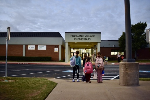 Children walk to Highland Village Elementary School. The school is marked for potential closure.