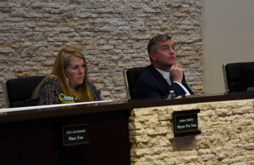 The mayor and mayor pro tem look to be listening intently from the dais.
