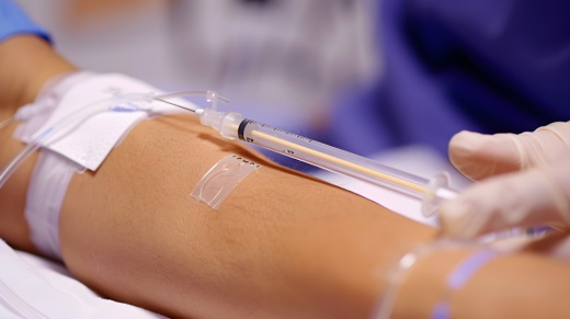 Patient with an IV in their arm in a medical setting