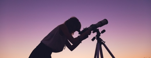 Person looking through a telescope.