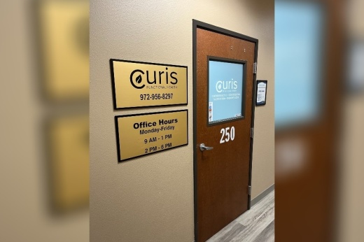 Exterior of an office with Curis sign next to door.