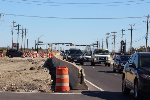 Cars driving on US 380 next to road construction