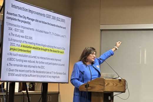 Carrillo holds up her fist during her presentation.