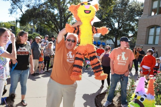 A man holds a pinata at a downtown Georgetown event.