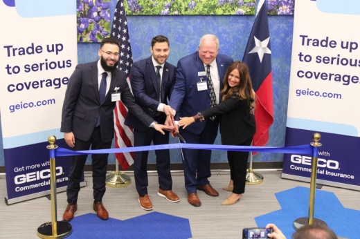 People at a ribbon cutting ceremony.