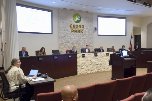 Image shows city council sitting at the dais.