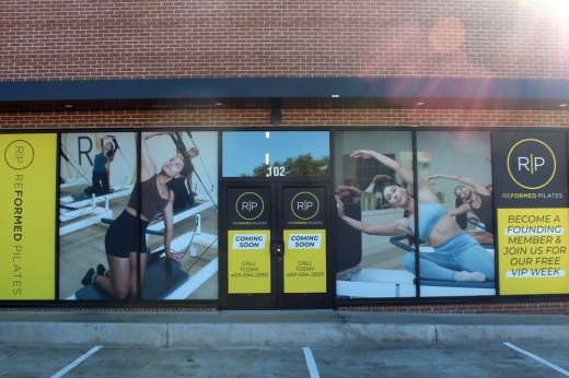 Exterior of building with Reformed Pilates signage in windows.