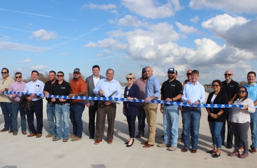 Officials cut a ribbon on a new road.