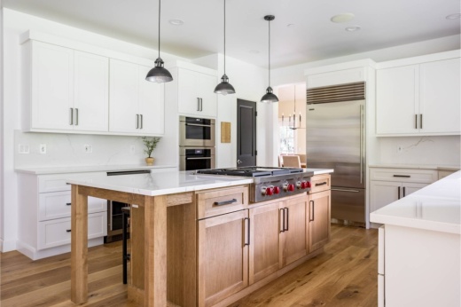 Kitchen with white and light brown color scheme.