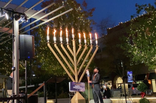 An outdoor menorah lighting.