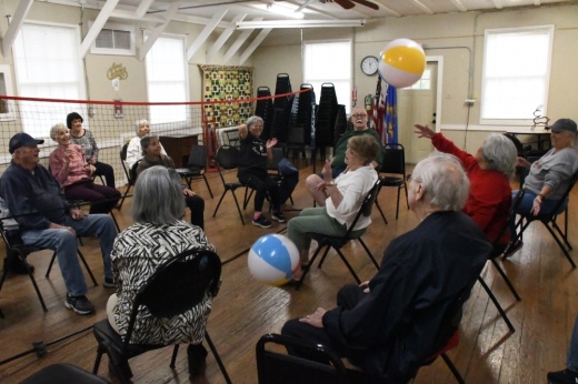 seniors sit and play volleyball