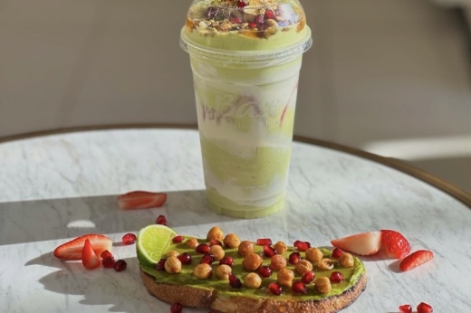 Chickpea avocado toast next to a green smoothie