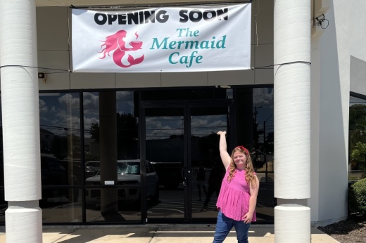 Leah Meyer underneath her cafe's coming soon banner. (Courtesy Mermaid Cafe)