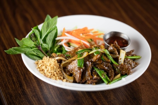 a plate of meat and rice from an Asian restaurant