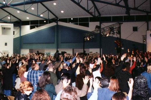 a group of people worship in a large space