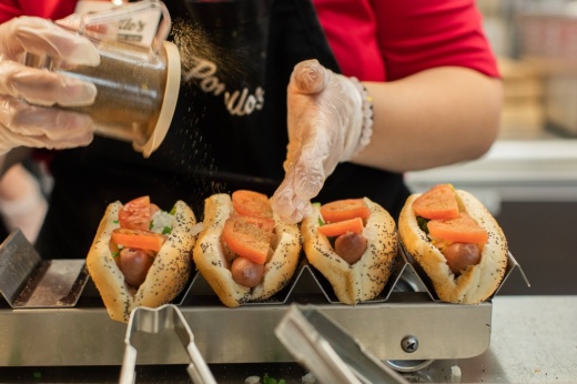 Person stacking hot dogs