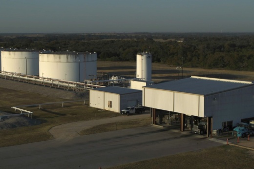 An aerial shot is shown with tankers on the right side in the parking garage.